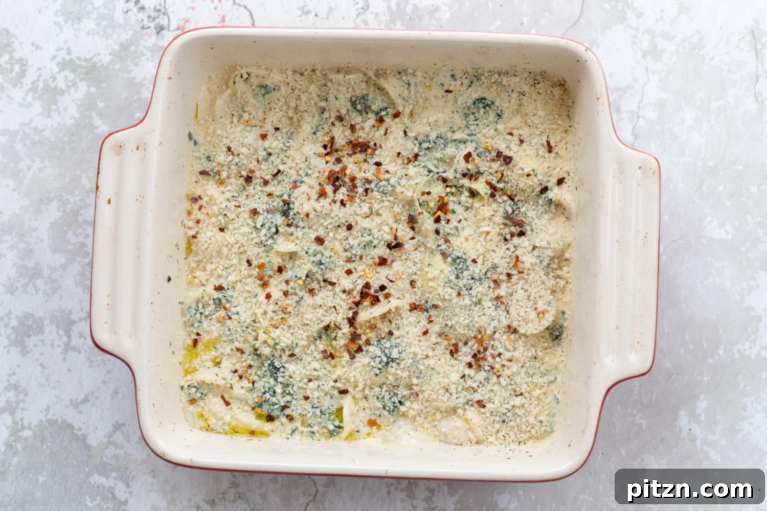 Creamy Vegan Spinach Artichoke Pasta Bake 2 spinach artichoke pasta bake topped with breadcrumb topping ready to go in the oven