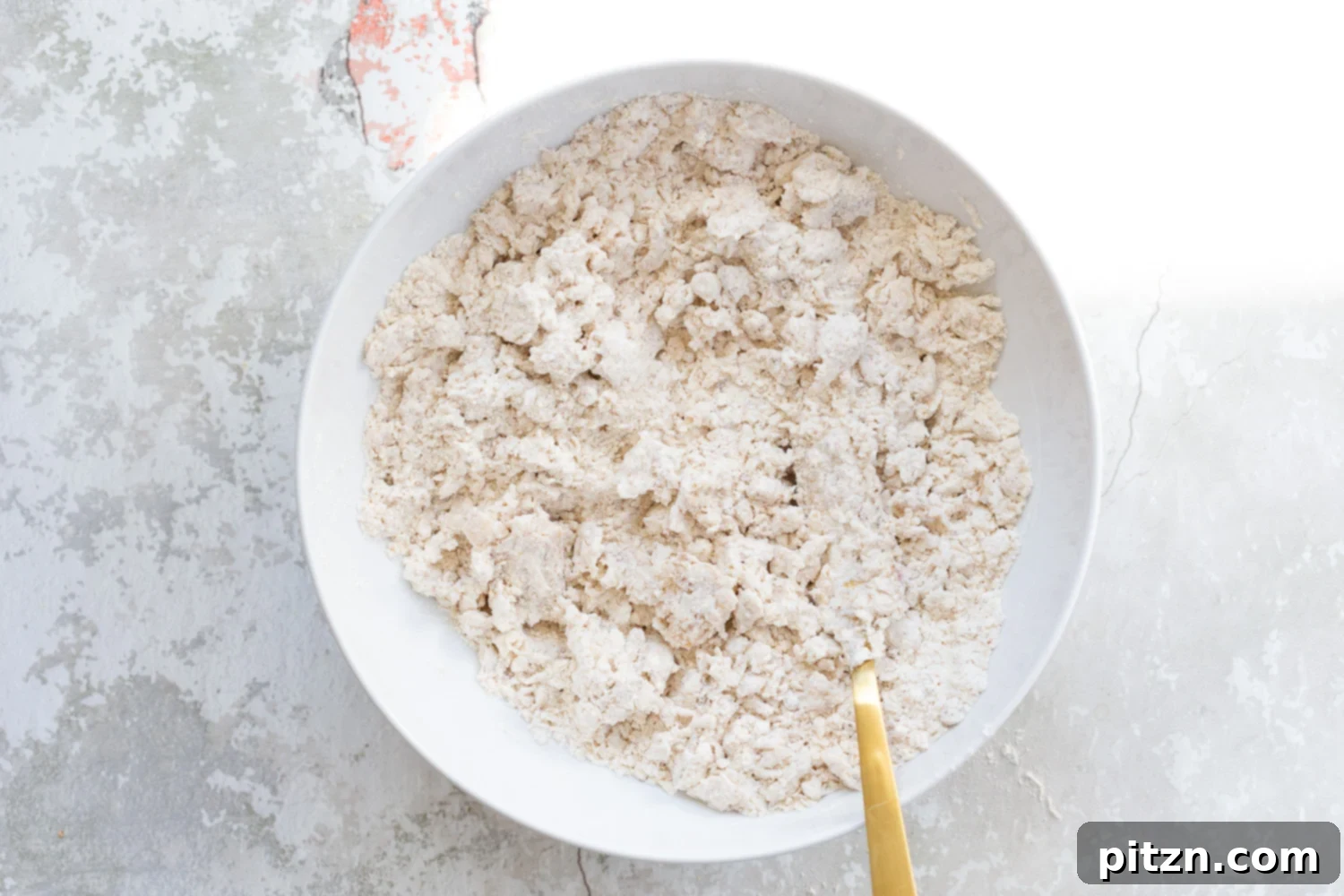 Coconut cream mixed with the dry ingredients for our Vegan Churro Scones in a white bowl