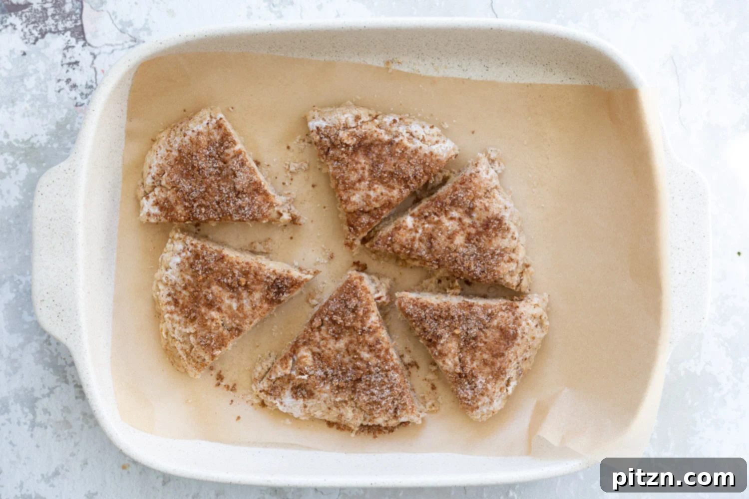 Sliced Dough for our Vegan Churro Scones in a parchment lined baking sheet. 