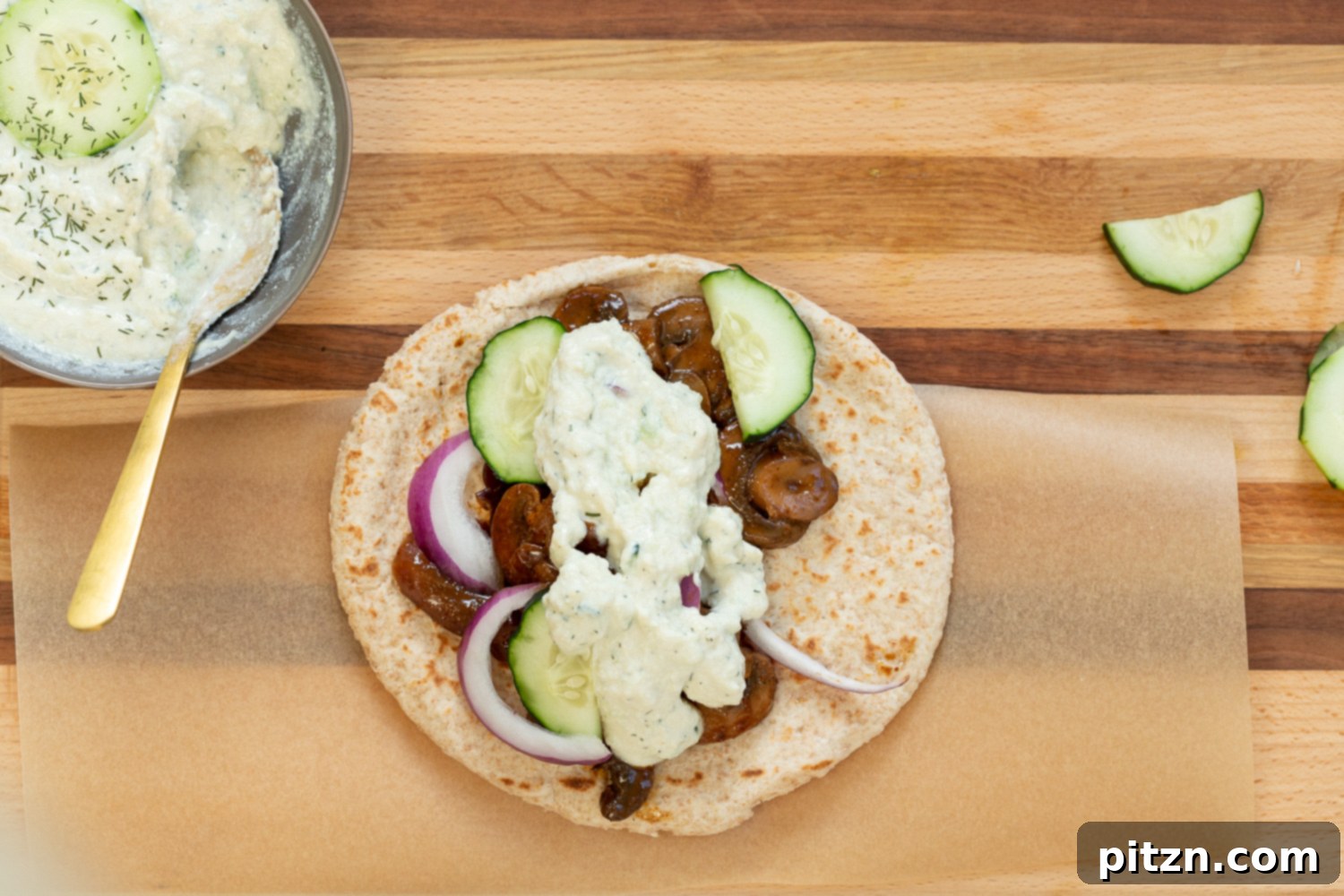 Close-up of a perfectly assembled Vegan Gyro with Mushrooms and Tzatziki, showcasing the easy 5-ingredient mushroom "meat" and 5-minute vegan tzatziki. This nut-free and potentially gluten-free recipe is a must-try.