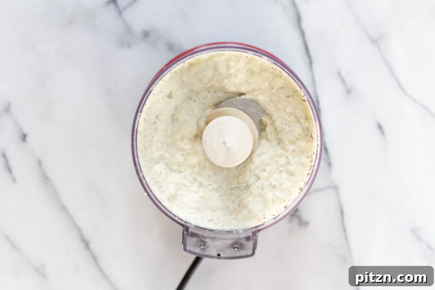 Creamy Vegan Tzatziki being prepared in a food processor, a key component for our Vegan Mushroom Gyros.