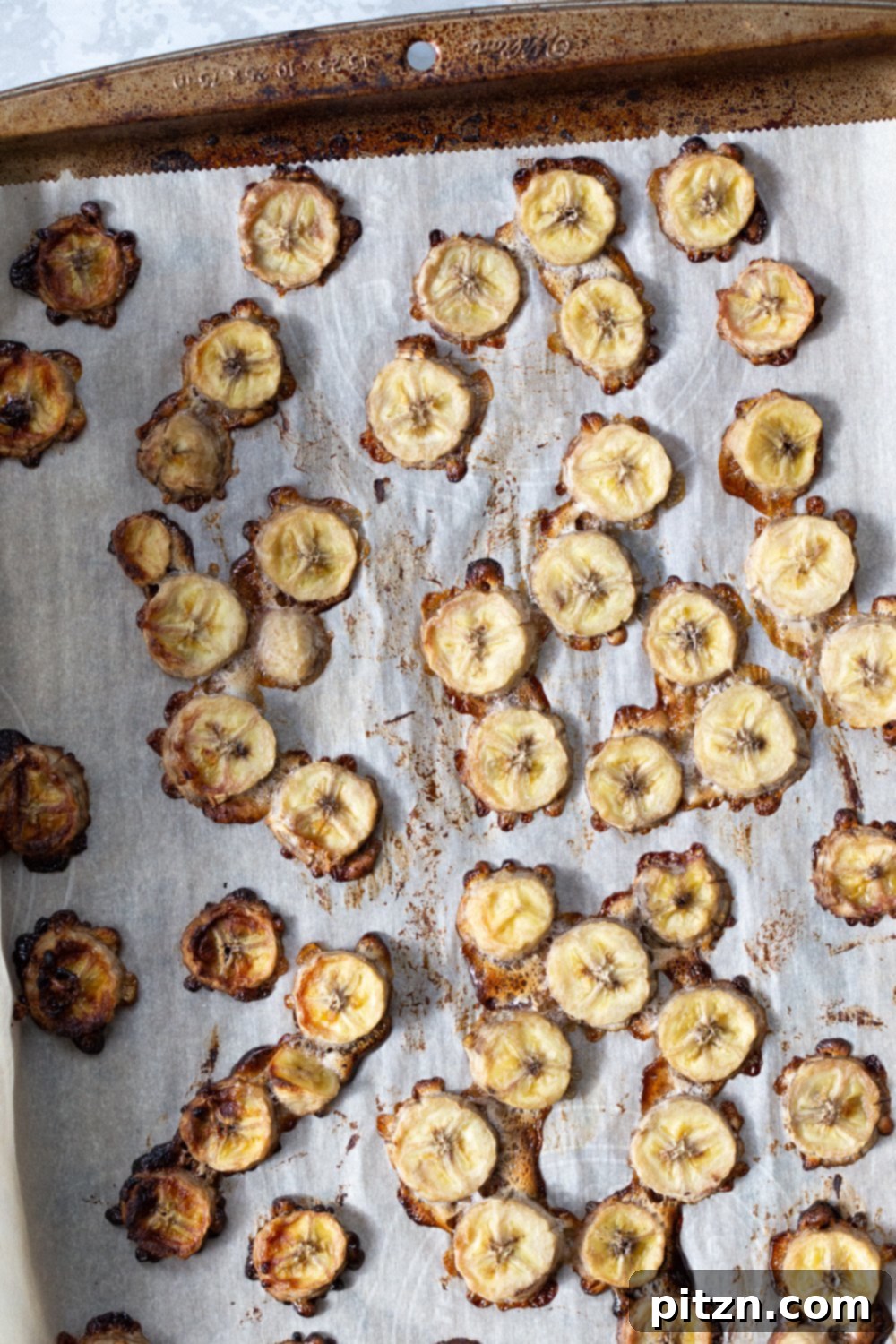Chewy Vegan Caramel Banana Granola Bars 2 overhead shot of sliced bananas roasting on a baking sheet