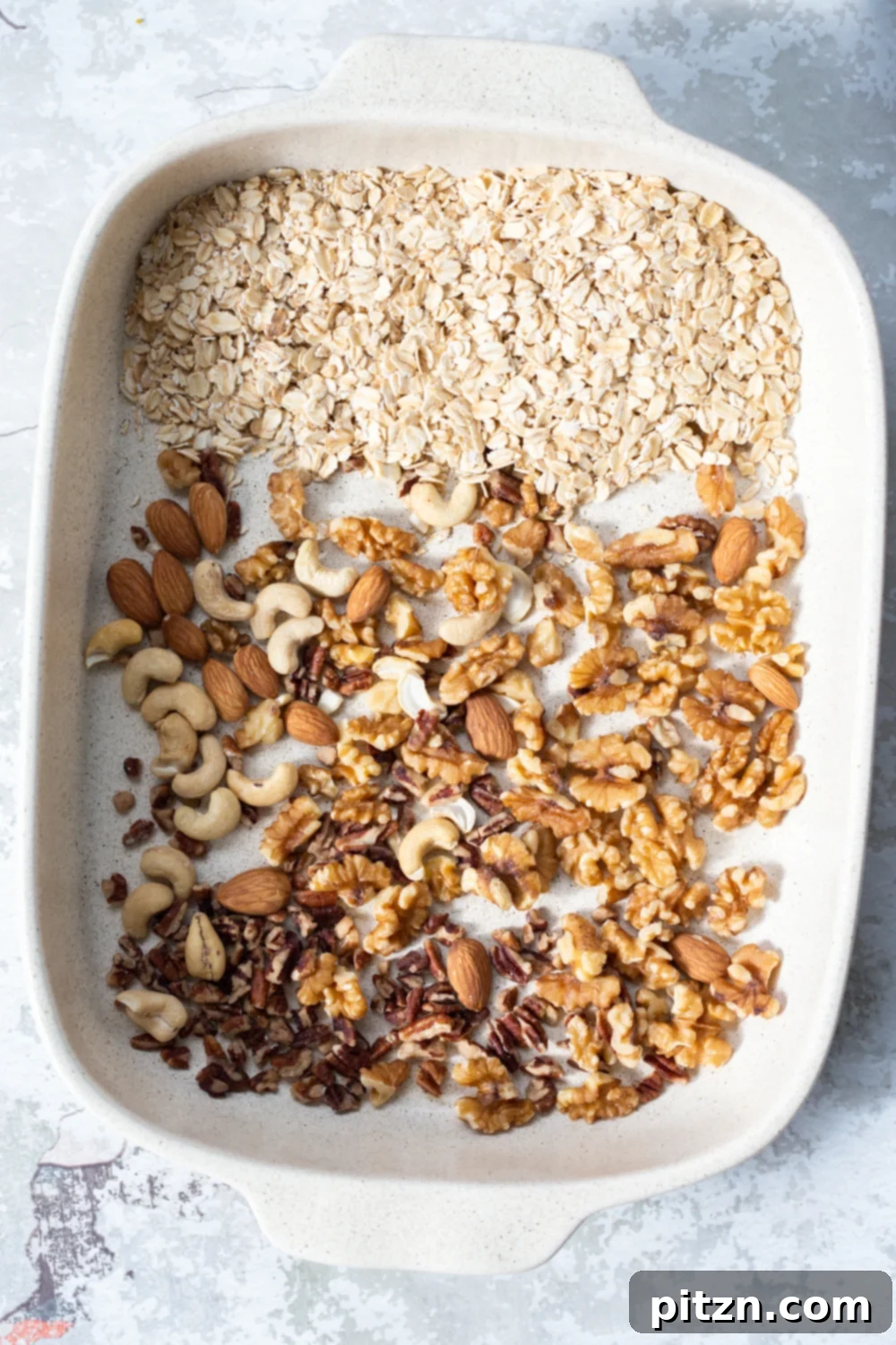Chewy Vegan Caramel Banana Granola Bars 3 overhead shot of a white casserole dish with ingredients for making vegan banana granola bars