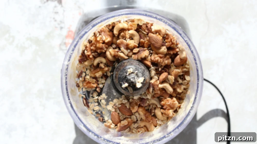Chewy Vegan Caramel Banana Granola Bars 4 nuts and oats being added to a food processor
