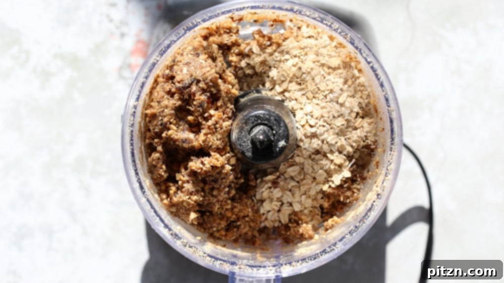Chewy Vegan Caramel Banana Granola Bars 7 overhead shot of dates and rolled oats in a food processor ready to be combined to make vegan granola bars