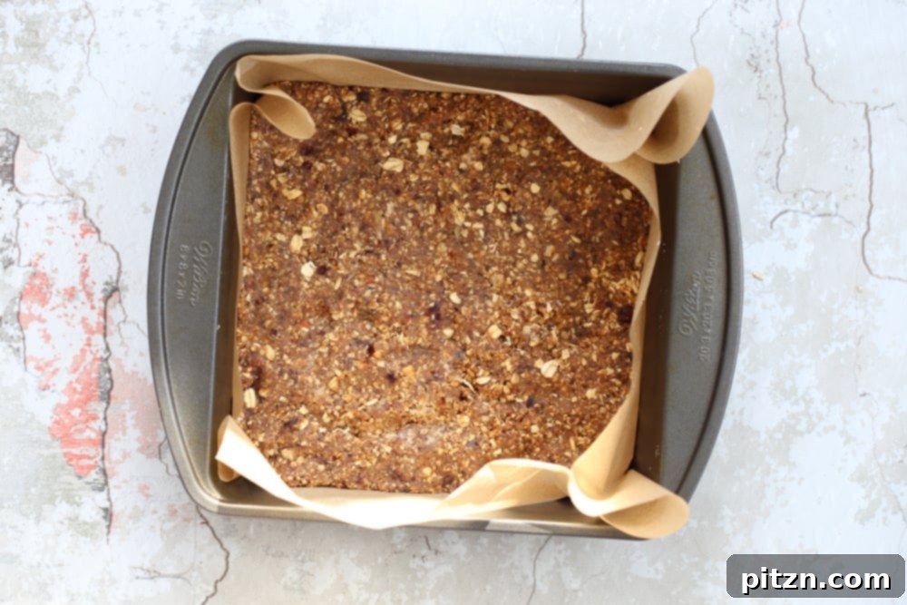 Chewy Vegan Caramel Banana Granola Bars 8 granola batter pressed into a square baking pan