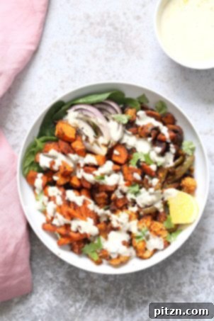 Cajun Roasted Vegetable Bowl with Garlic Sauce. Featuring mushrooms, cauliflower, sweet potato, peppers, and onions tossed in a homemade cajun spice blend and roasted. Served with crunchy greens and creamy garlic sauce. Vegan, Gluten-free, Soy-free, with a nut-free option.