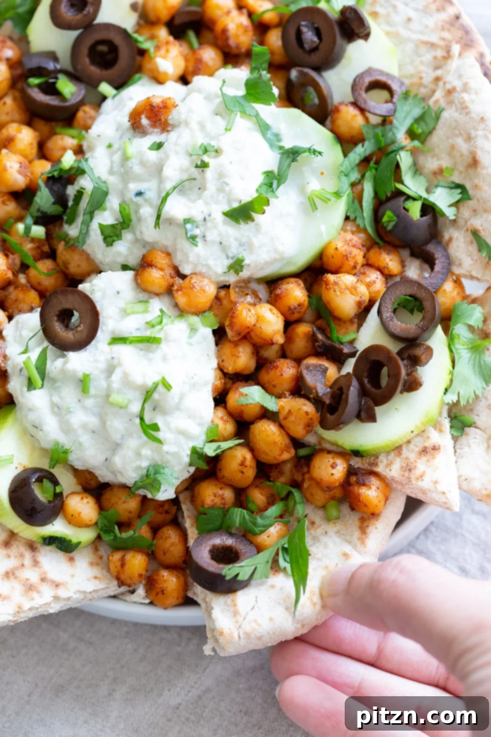 Mediterranean Shawarma Nacho Extravaganza (Vegan) 2 Vibrant Vegan Mediterranean Nachos featuring shawarma-spiced chickpeas, creamy tzatziki, fresh olives, and crisp cucumber on toasted pita bread, perfect for parties and potlucks.