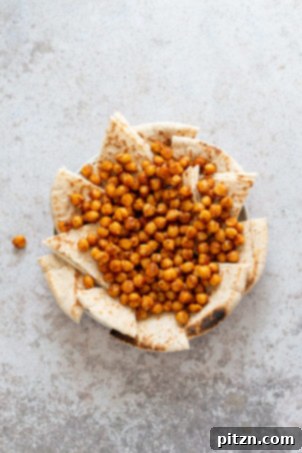Mediterranean Shawarma Nacho Extravaganza (Vegan) 5 Toasted pita bread and perfectly spiced shawarma chickpeas plated, forming the base of our delicious Mediterranean Nachos.