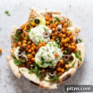 Mediterranean Shawarma Nacho Extravaganza (Vegan) 9 Mediterranean Nachos with Shawarma Chickpeas, Tzatziki, Olives, Cucumber, warm toasted Pita bread. Great Appetizer for parties or potluck. #Vegan #Veganricha #Mediterraneannachos