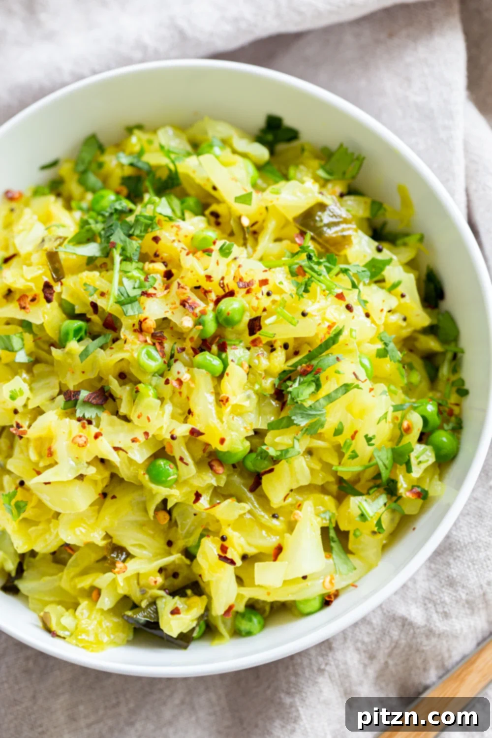 A beautifully presented bowl of Instant Pot Indian Cabbage and Peas, garnished with fresh cilantro, ready to be served.