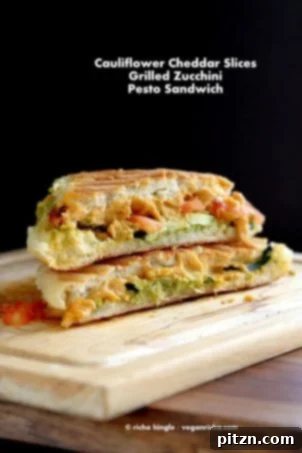 Effortless Plant-Based Pesto 6 Cauliflower Cheddar, pesto, Grilled zucchini Sandwich on a wood board #VeganRicha