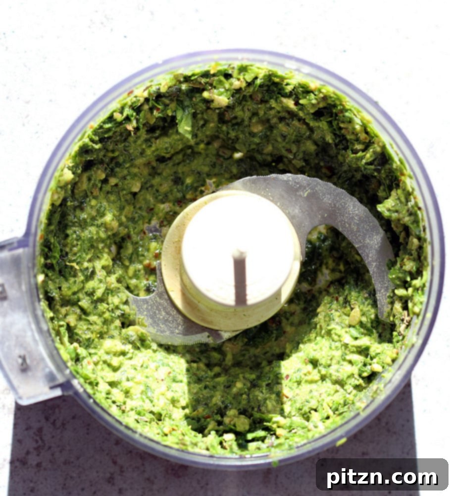 Effortless Plant-Based Pesto 7 Vegan Pesto in a food processor, mid-preparation