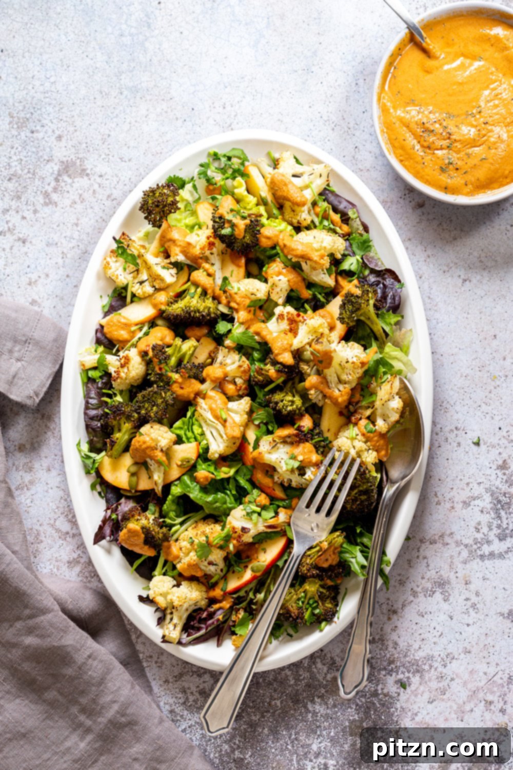 Roasted Broccoli Cauliflower Salad with Sun dried Tomato Dressing on white serving platter