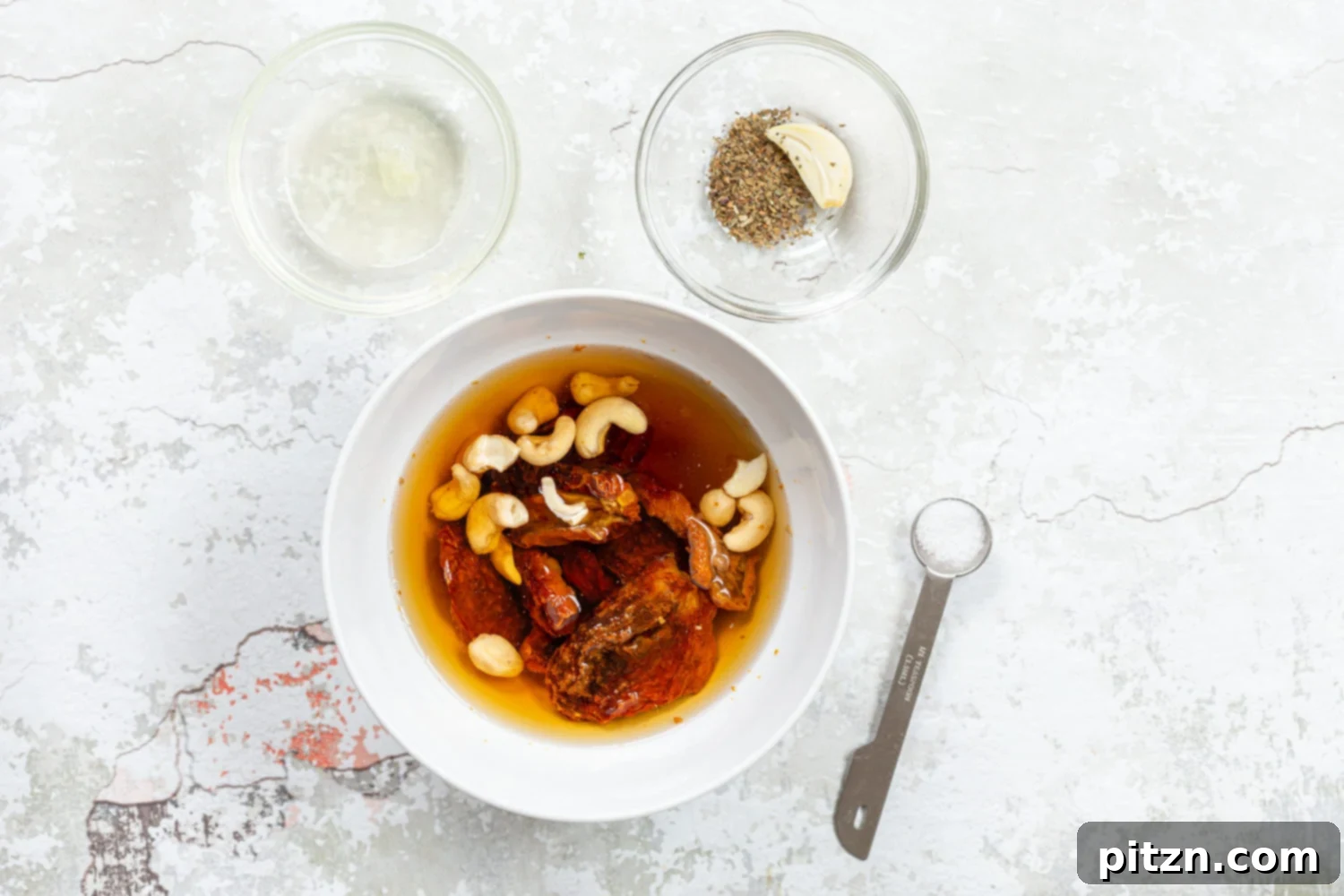Ingredients for sundried tomato dressing in bowls