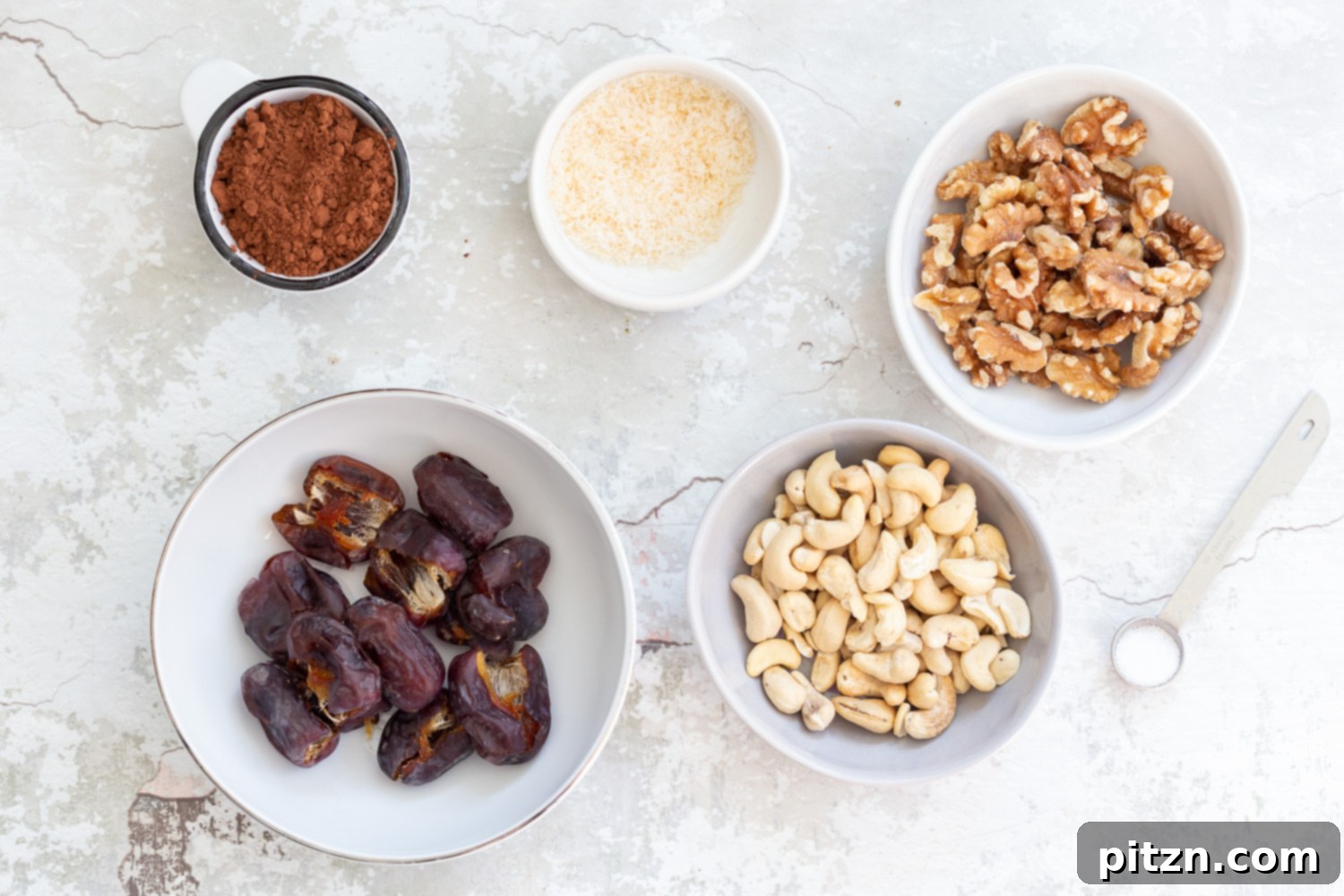Fudgy Raw Vegan Grain-Free Brownie Bites 4 Ingredients for Raw Vegan Brownie Bites, including nuts, dates, and cocoa, arranged in separate bowls, ready for preparation.