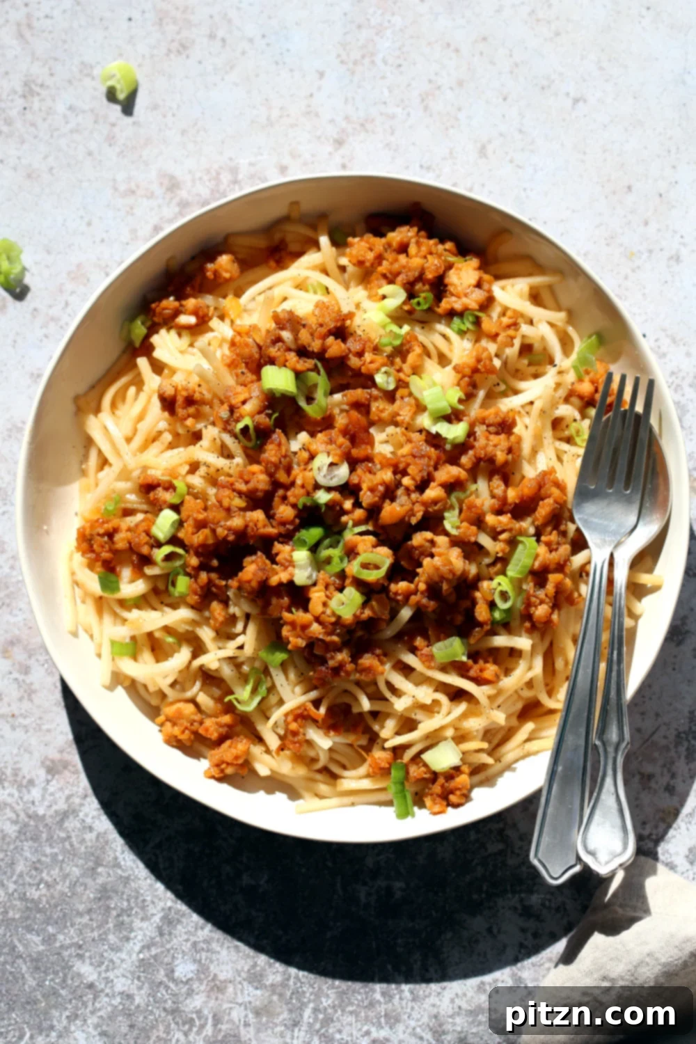 Zesty Lemongrass Tempeh with Sesame Noodles 2 Sesame Noodles with Lemongrass Tempeh Crumbles in a white bowl