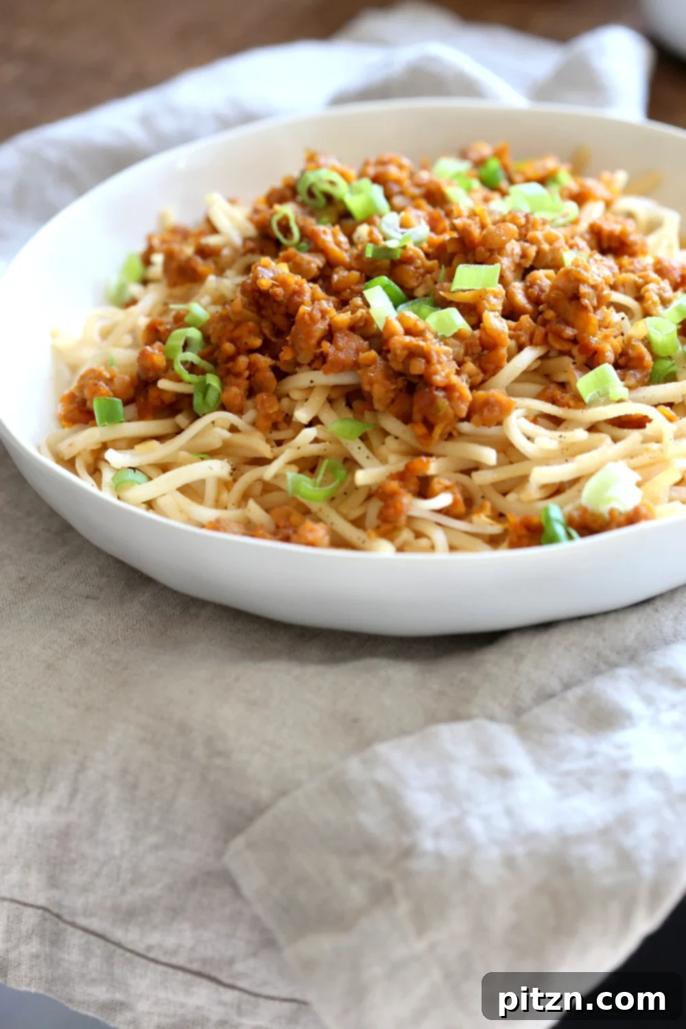 Zesty Lemongrass Tempeh with Sesame Noodles 3 Sesame Noodles with Lemongrass Tempeh Crumbles in a white bowl