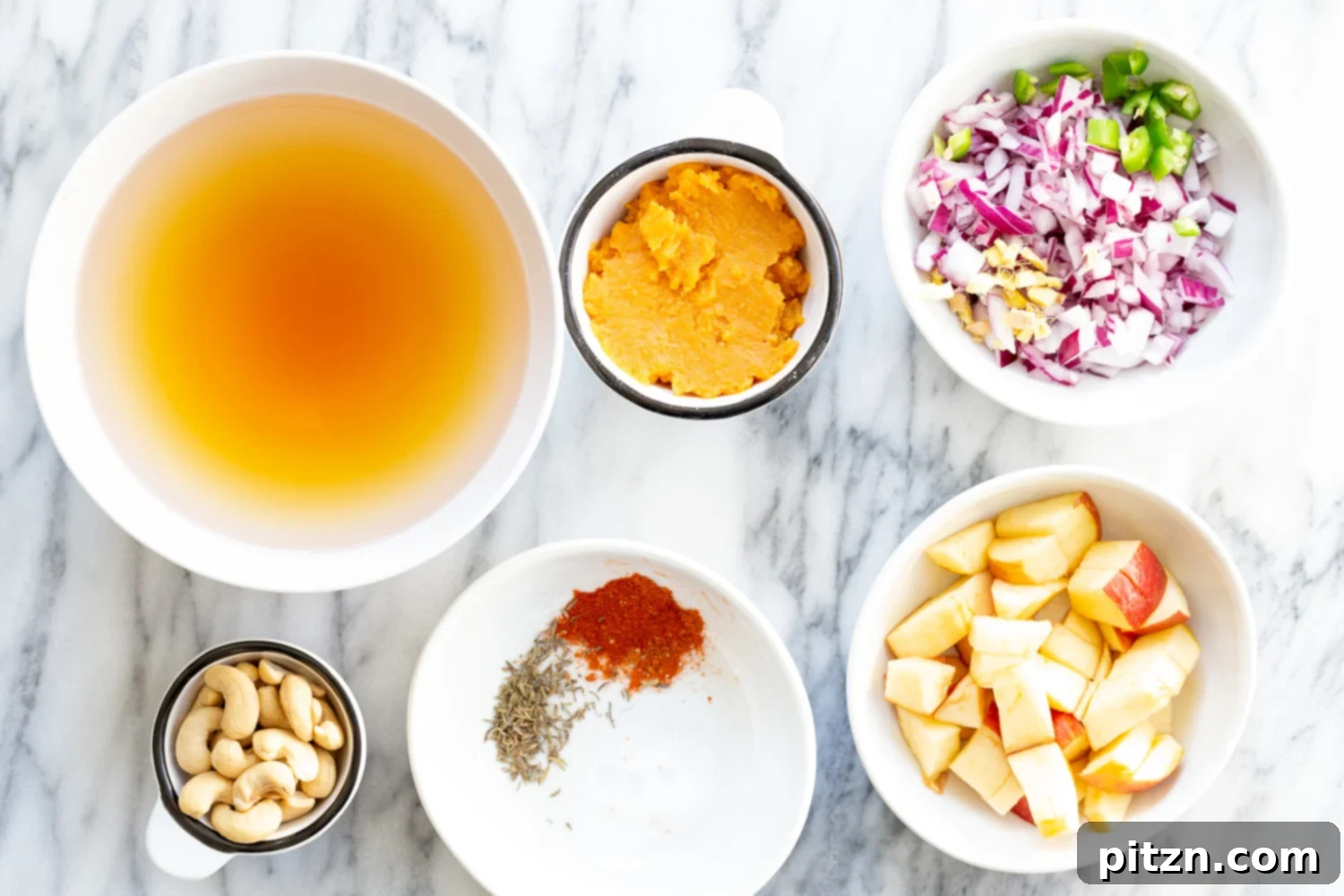 Velvety Vegan Instant Pot Pumpkin Soup 3 A selection of fresh, wholesome ingredients arranged in bowls, ready for making Creamy Vegan Pumpkin Apple Soup
