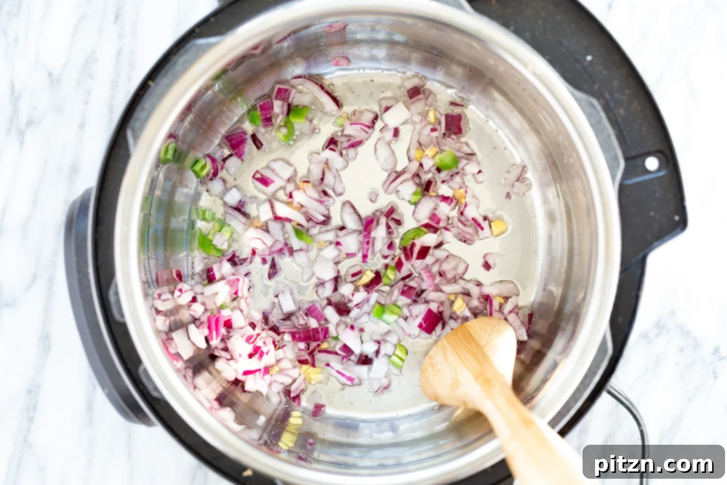 Onion, garlic, and ginger sautéed in the Instant Pot, forming the aromatic base for the Vegan Pumpkin Soup
