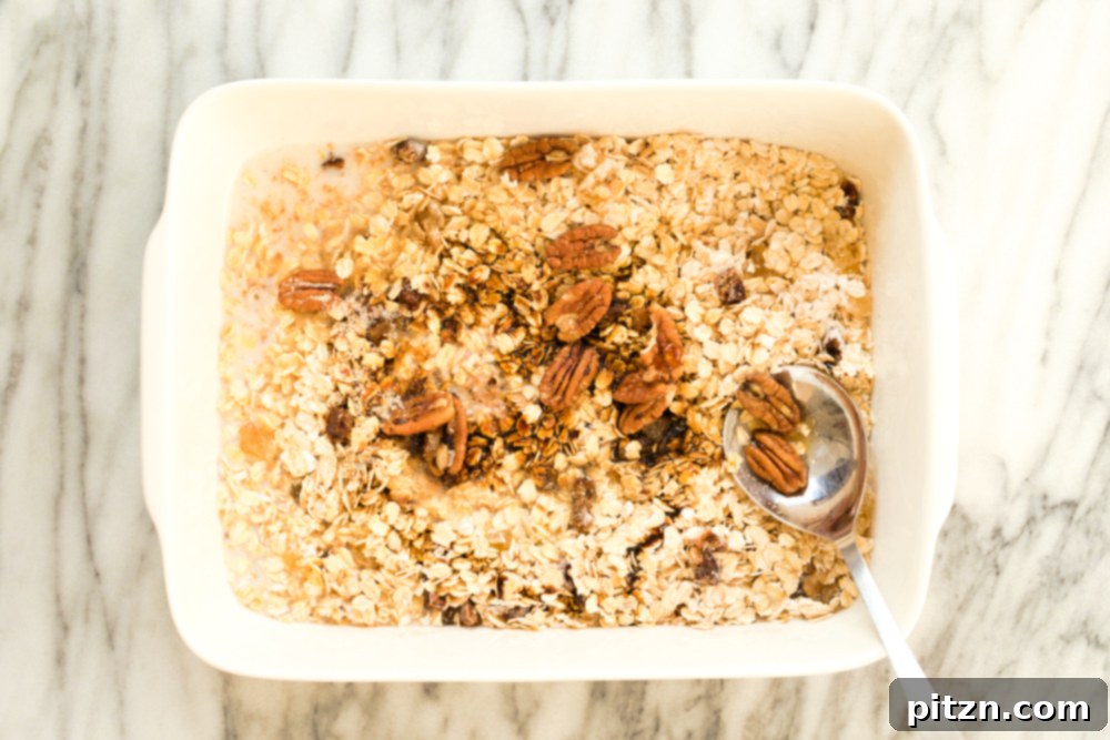 Oil-Free Vegan Gingerbread Oatmeal Delight 5 Dry ingredients for Vegan Gingerbread Baked Oatmeal in a white baking dish