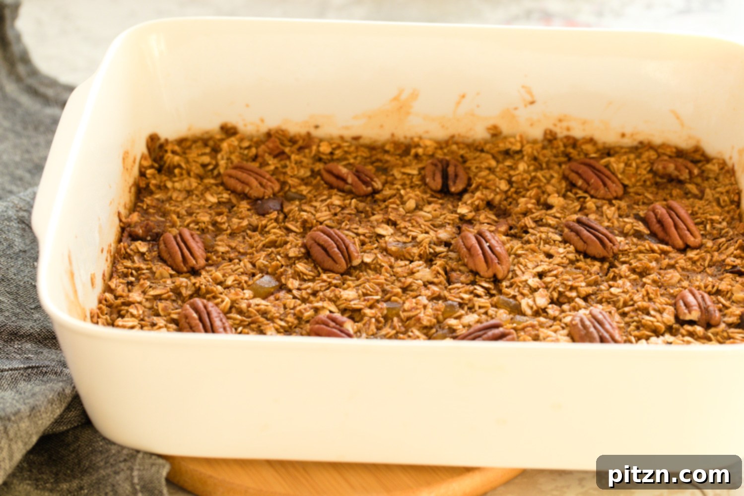 Oil-Free Vegan Gingerbread Oatmeal Delight 8 Vegan Gingerbread Baked Oatmeal in a white baking dish
