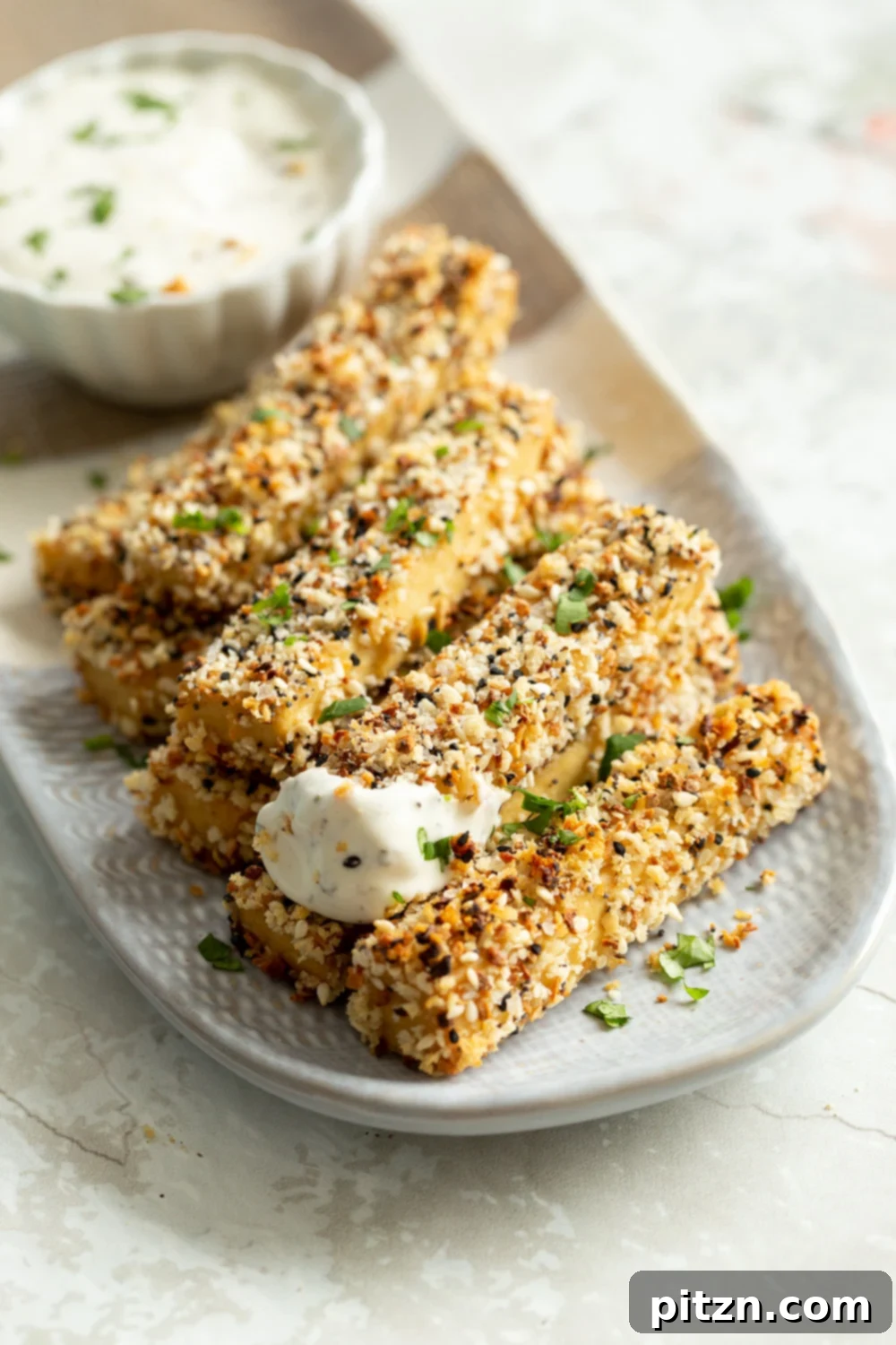 Crispy Everything Bagel Tofu 8 Everything Bagel Tofu served on a white and grey platter, ready to enjoy