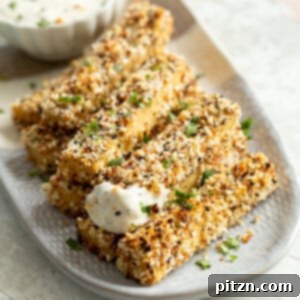 Crispy Everything Bagel Tofu 9 Our Everything Bagel Tofu on a white and grey serving platter