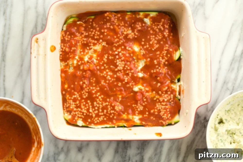 Creamy Vegan Gluten-Free Zucchini Lasagna with Tofu Ricotta 8 Layering Our Vegan Gluten free Zucchini Lasagna in a cream baking dish