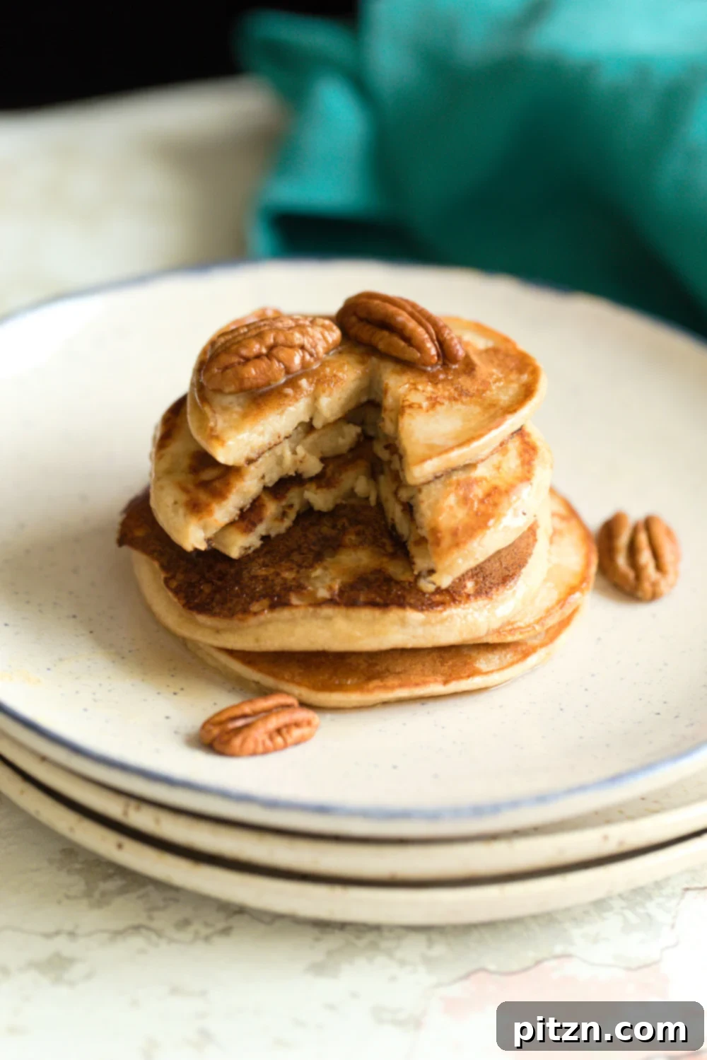 A second view of beautifully stacked Vegan Banana Oat Pancakes, showcasing their golden-brown exterior and inviting appeal.