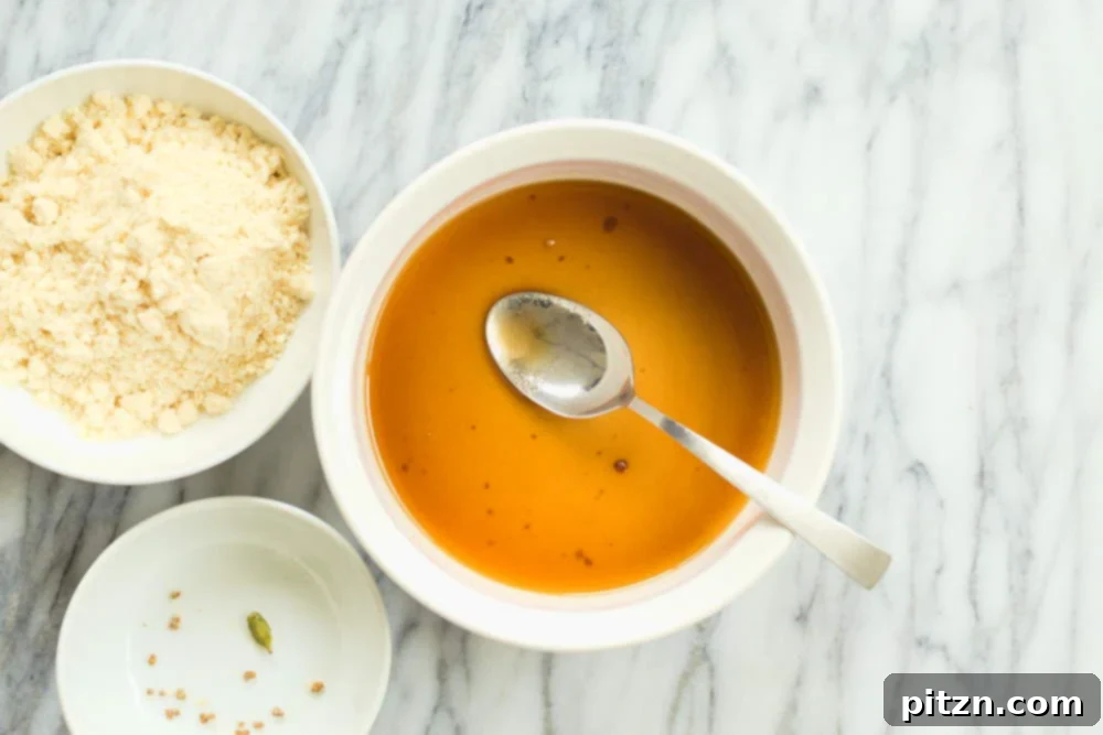 The sugar and hot water mixture for our Vegan Almond Halwa, ready in a white baking dish.