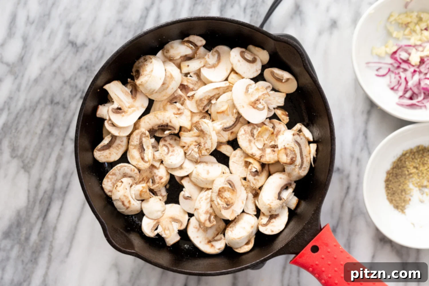 Sliced mushrooms caramelizing in a cast iron skillet