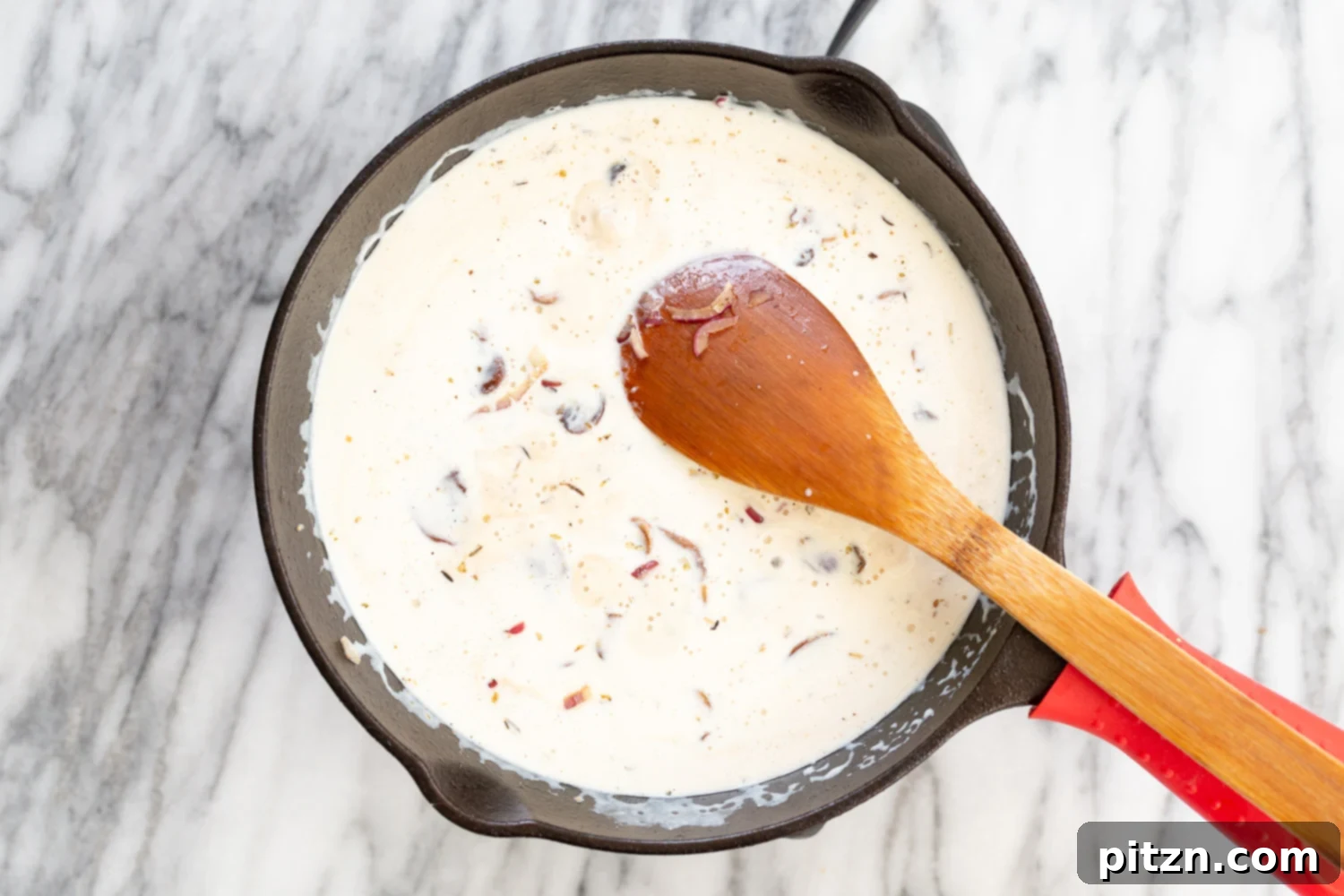 Finished creamy vegan mushroom wine sauce in a cast iron skillet