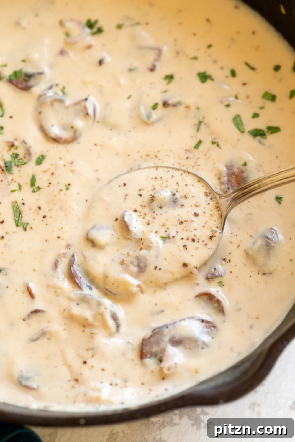 Creamy Vegan Mushroom Sauce in a black skillet, ready to serve