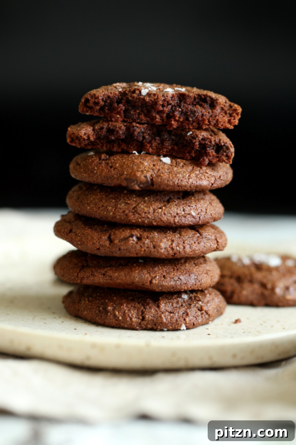 Close-up of freshly baked Vegan Brownie Cookies on a white plate, highlighting their rich texture and chocolatey goodness