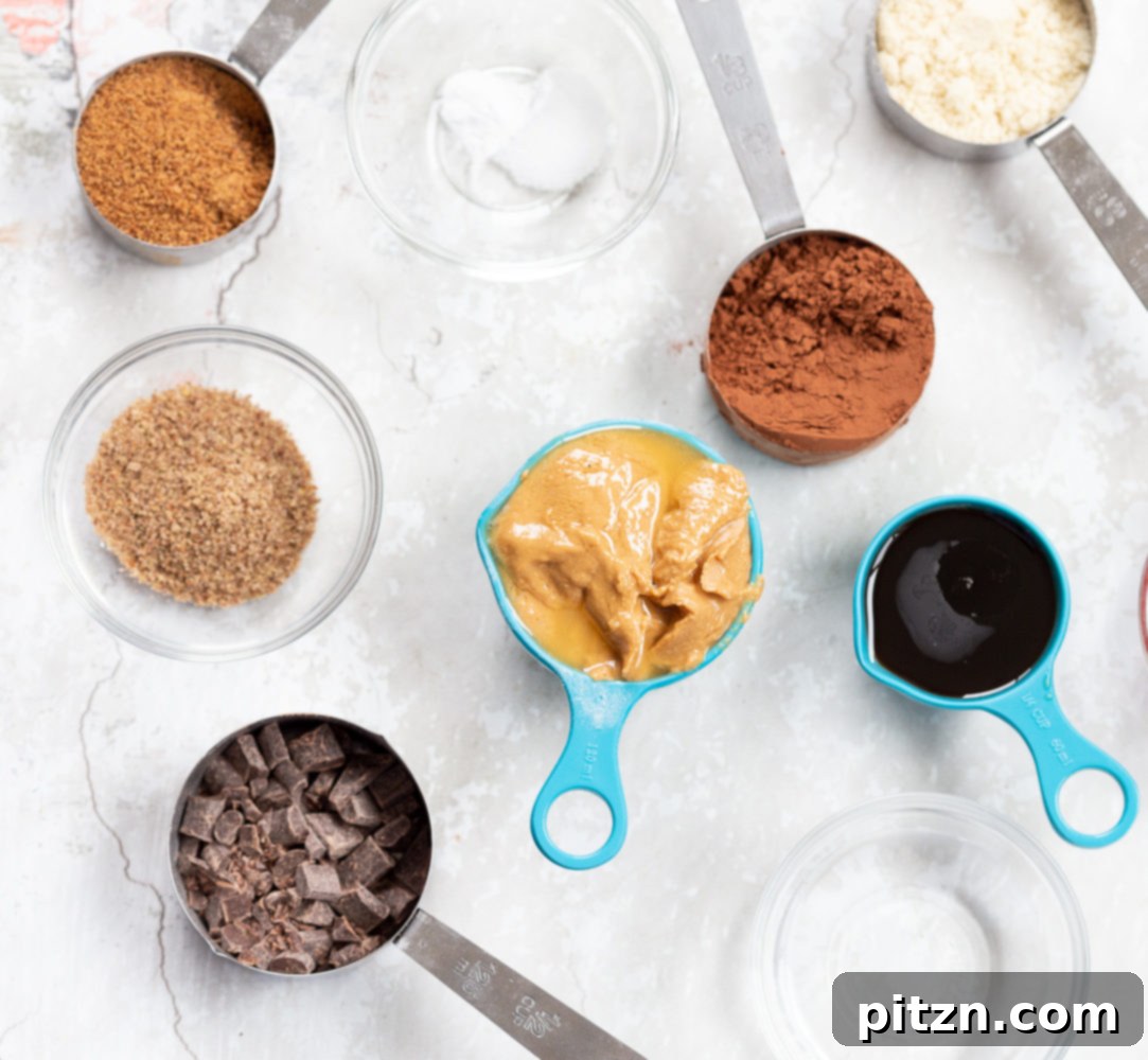 Bowls of prepped ingredients for Vegan Brownie Cookies: maple syrup, flax meal, almond flour, cocoa powder, nut butter, and chocolate chips