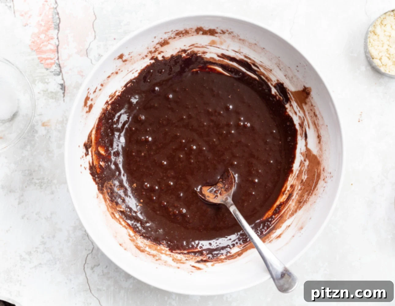 The smooth, dark chocolate batter for Vegan Brownie Cookies in a white bowl, ready for the next step