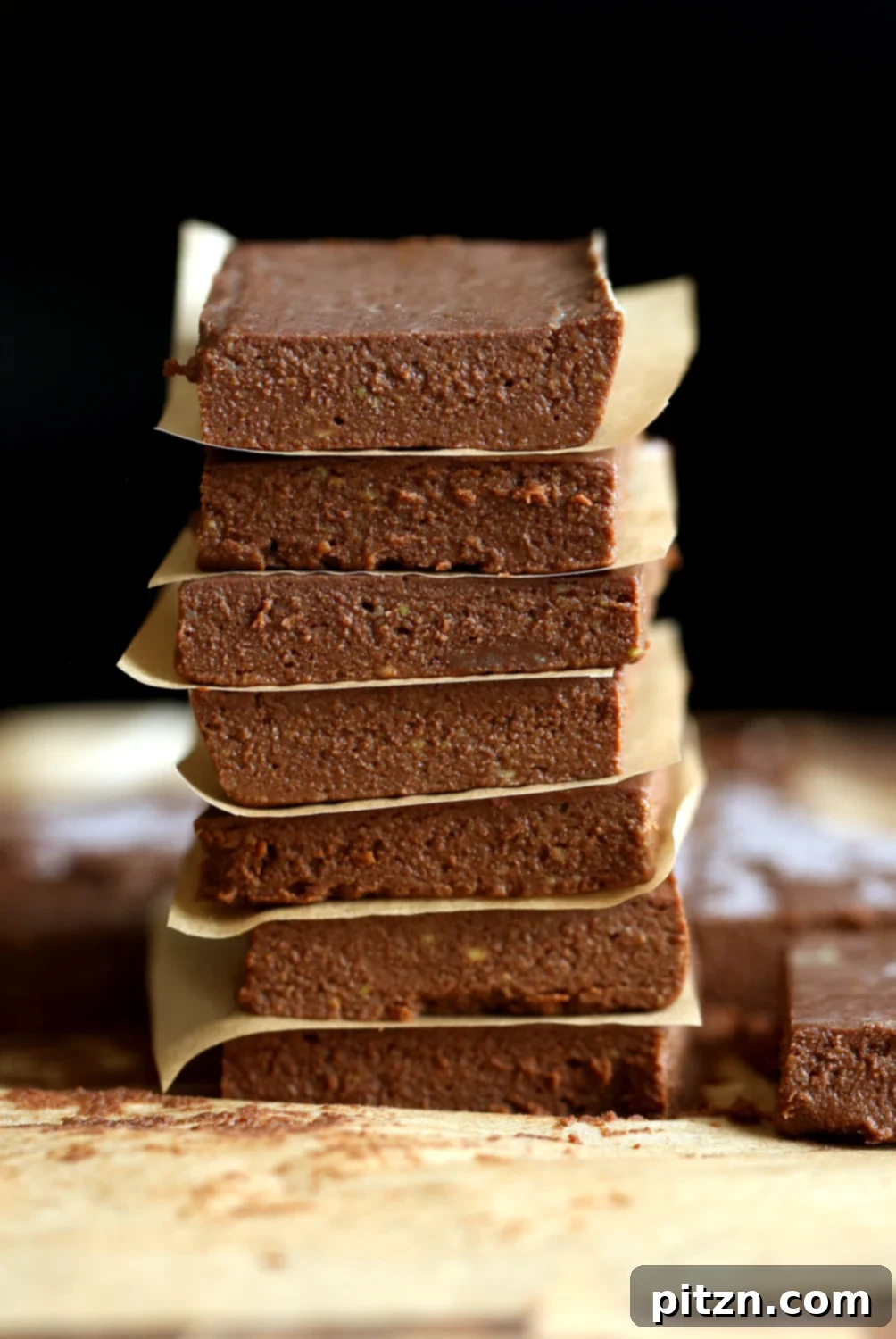 Easy 5-Ingredient Chocolate Avocado Freezer Fudge 10 A stunning arrangement of Vegan Chocolate Avocado Freezer Fudge Bars on parchment paper, ready to be served and enjoyed.
