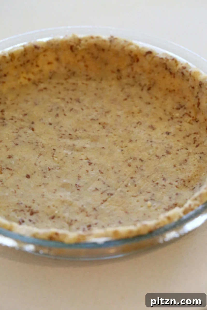 almond flour pie crust a healthy vegan almond flour pie crust in a Pyrex pie dish ready for baking