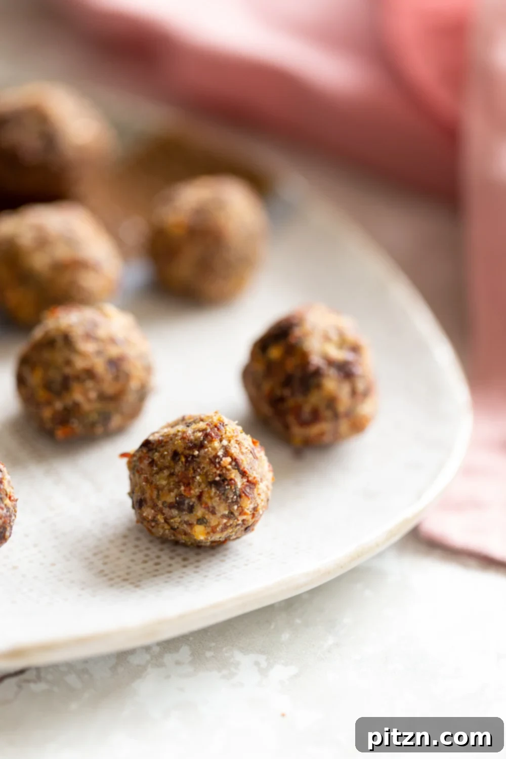 A vibrant close-up of gluten-free vegan pizza snack bites artfully arranged on a white plate, highlighting their rich textures and inviting savory appeal. Perfect for a healthy, low-carb, and plant-based diet.