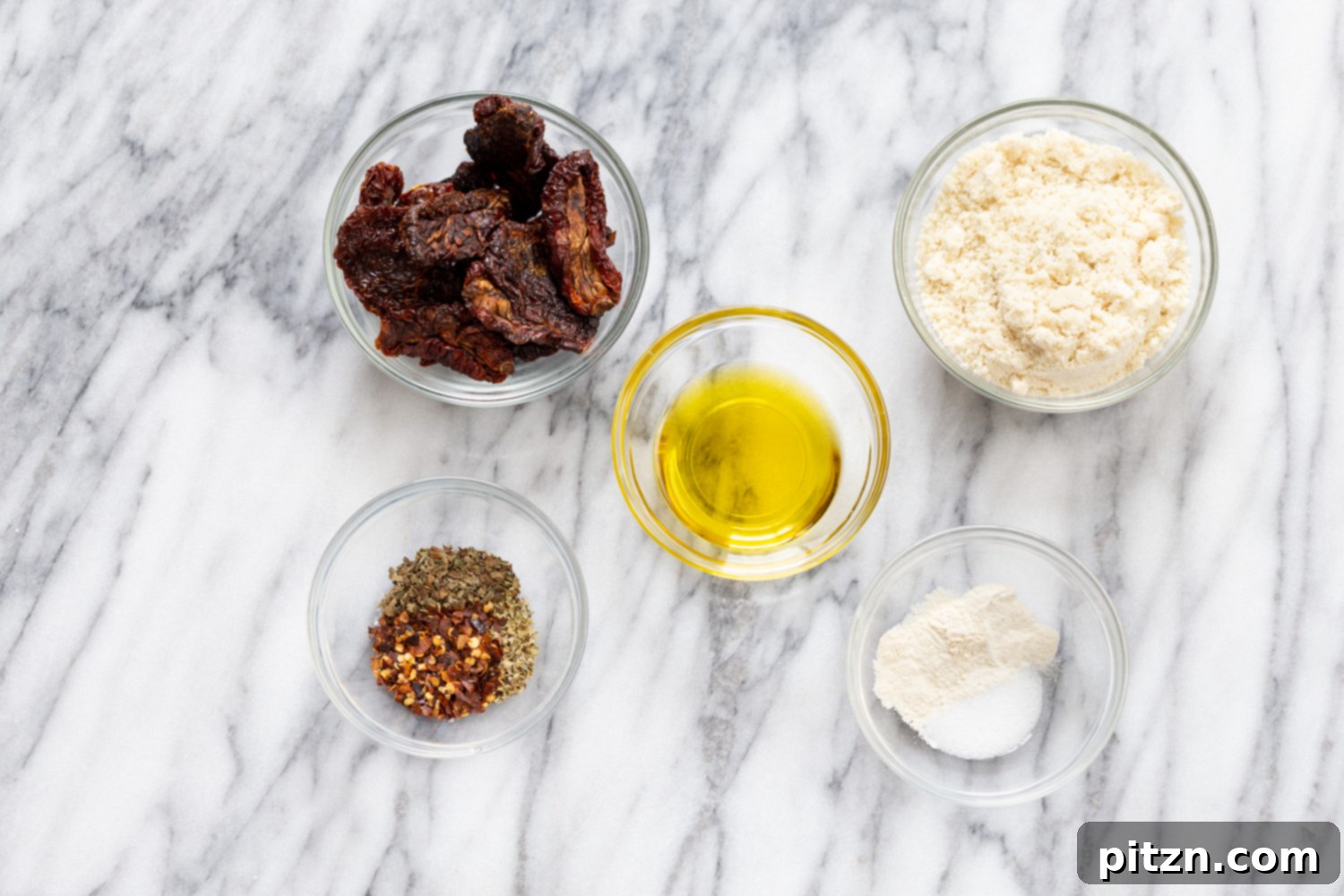 A visual guide showing a bowl of sun-dried tomatoes, a key ingredient for vegan pizza bites, ready to be processed. This image highlights the quality and readiness of ingredients for a healthy, grain-free snack.