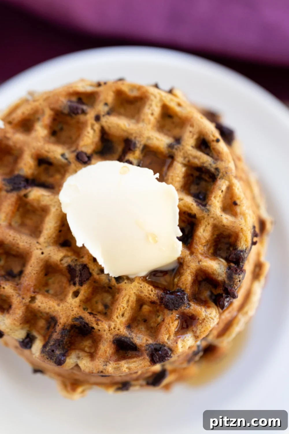 overhead shot of a stack of healthy vegan oatmeal chocolate chip waffles topped with ice cream