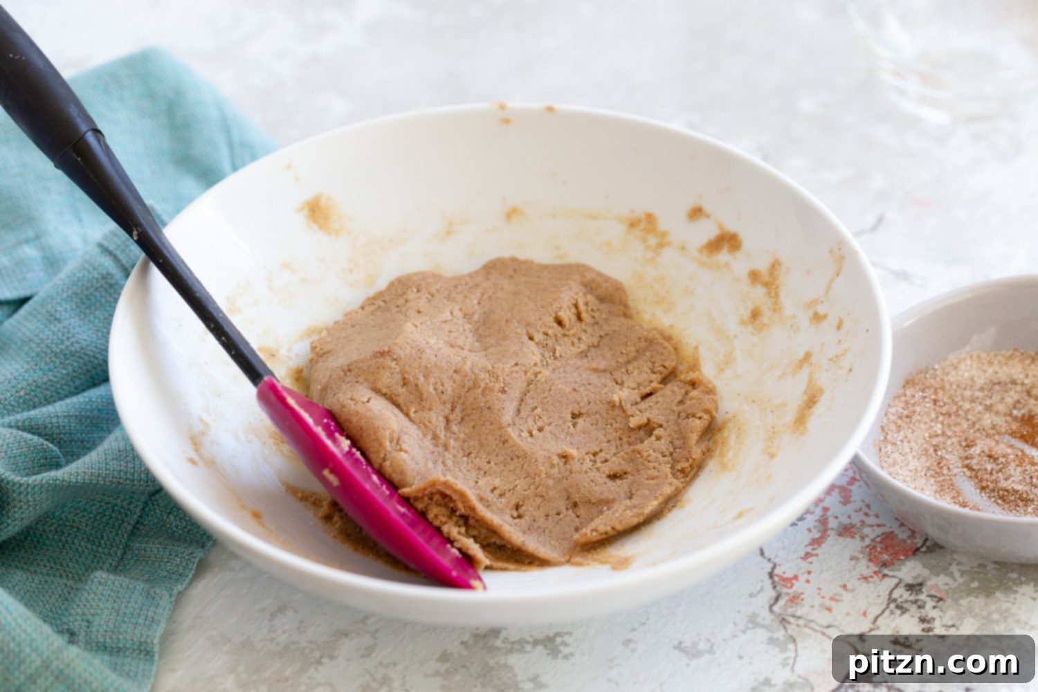 Snickerdoodle bites Batter for rolling vegan Snickerdoodle bites in a white bowl