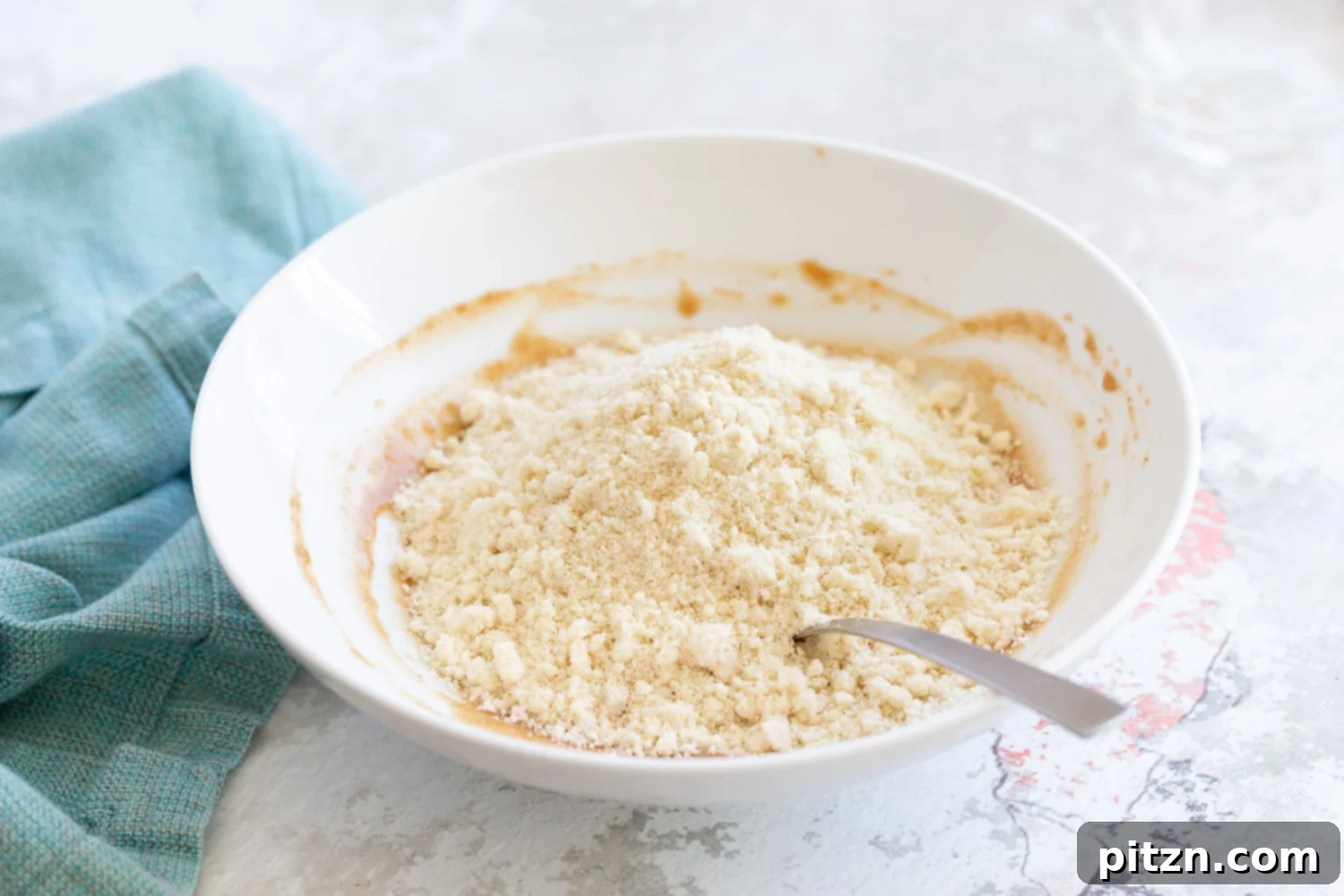 Snickerdoodle bites Oat flour and ground nuts being mixed with nut butter for making snack bites