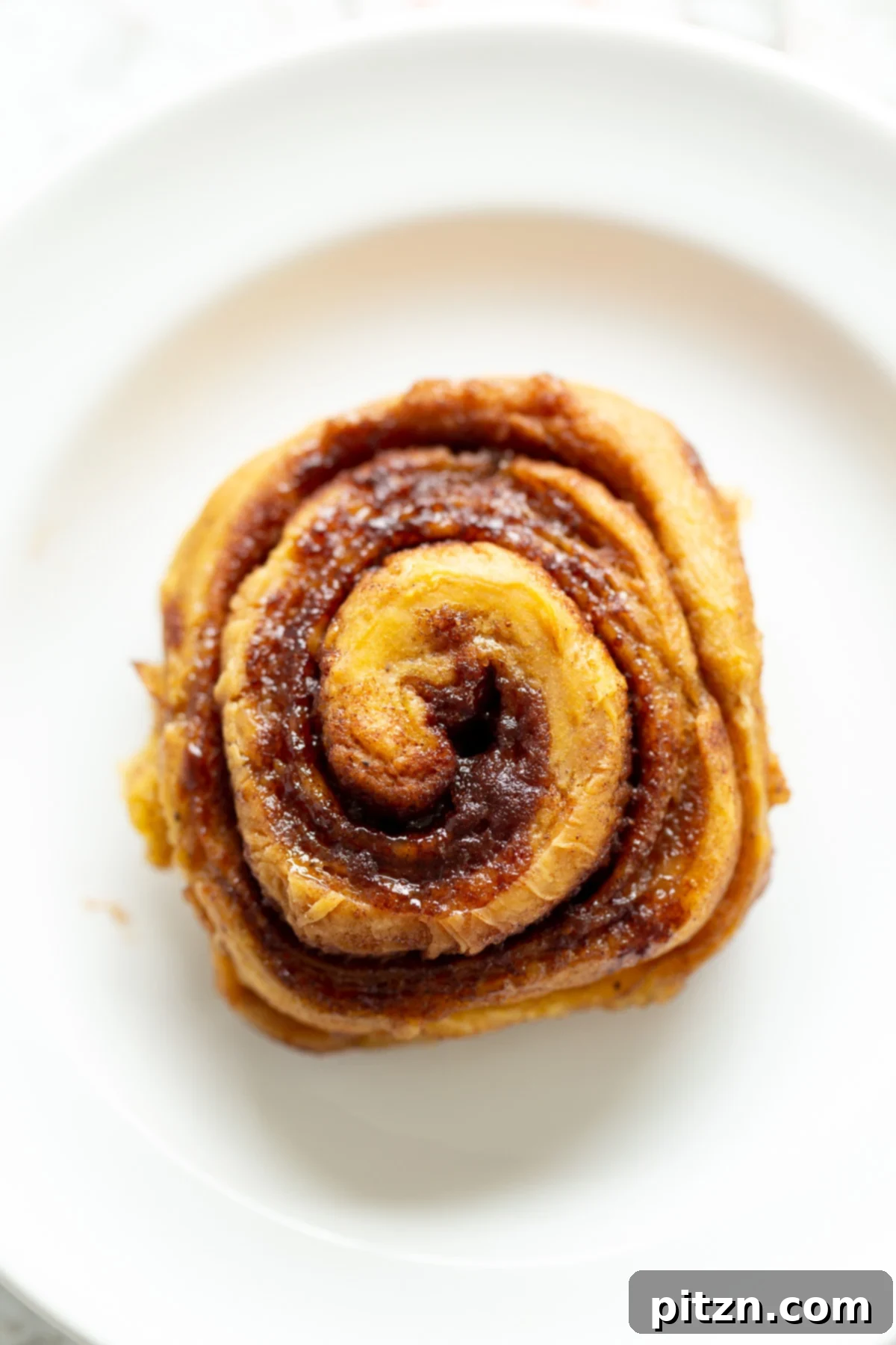 no yeast cinnamon rolls overhead shot of a vegan sweet potato no yeast cinnamon roll on a white plate
