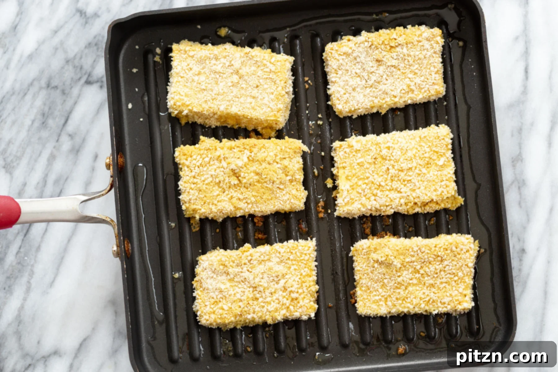 Frying Tofu Katsu breaded tofu slices being fried in a pan to make crispy katsu