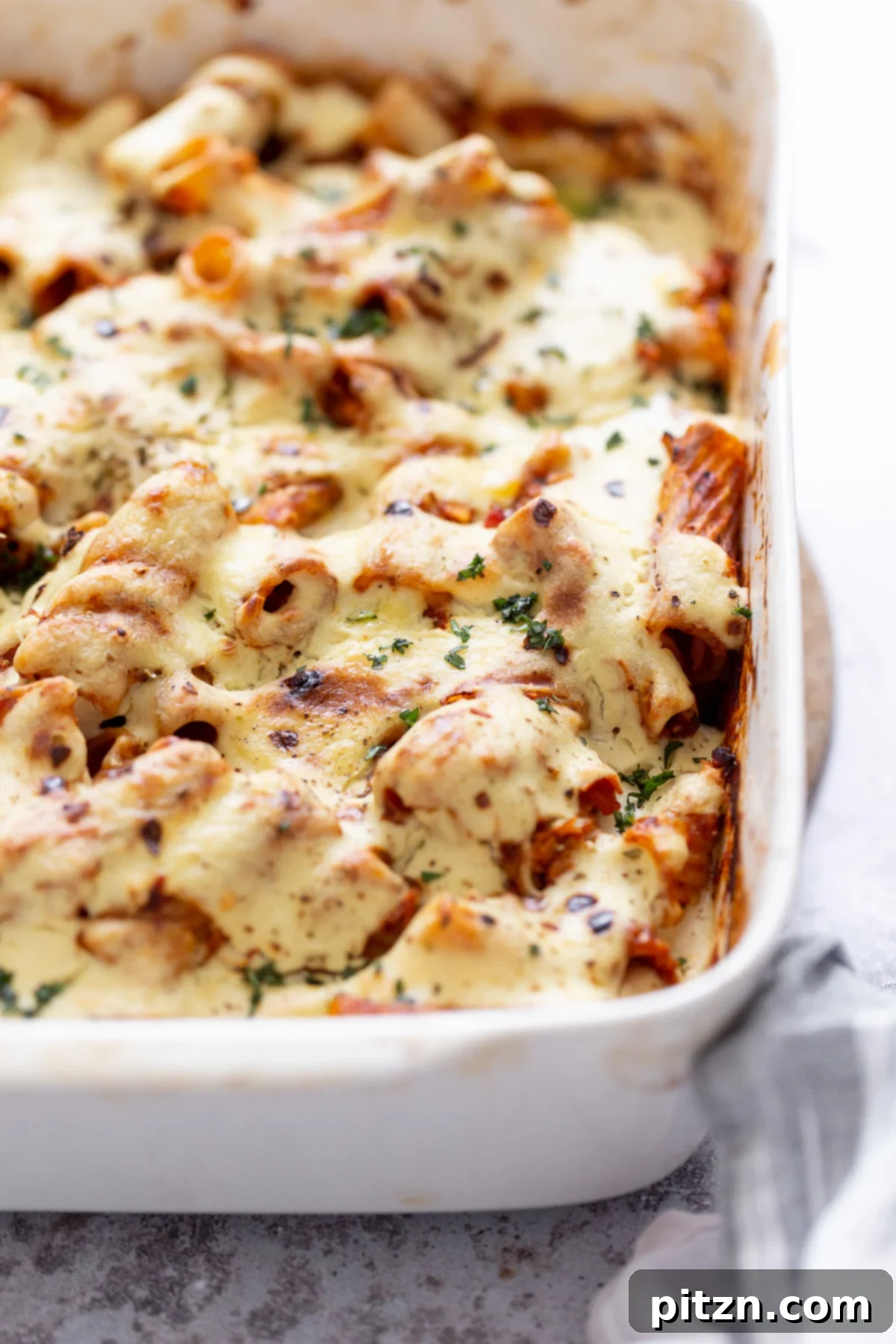 baked rigatoni side view of a casserole dish with baked vegan rigatoni with tofu mozzarella