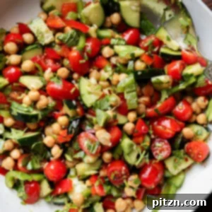 Balela chickpea cherry tomato cucumber salad in a white bowl