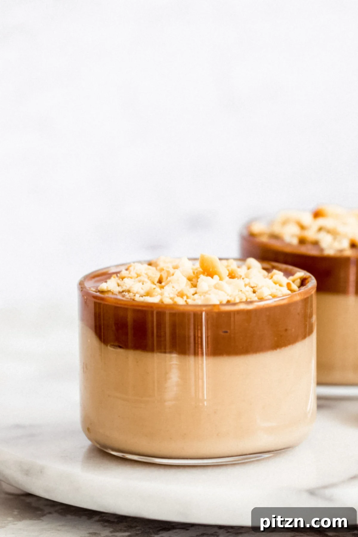 Close-up of Vegan Peanut butter mousse in glass ramekins, showing distinct layers