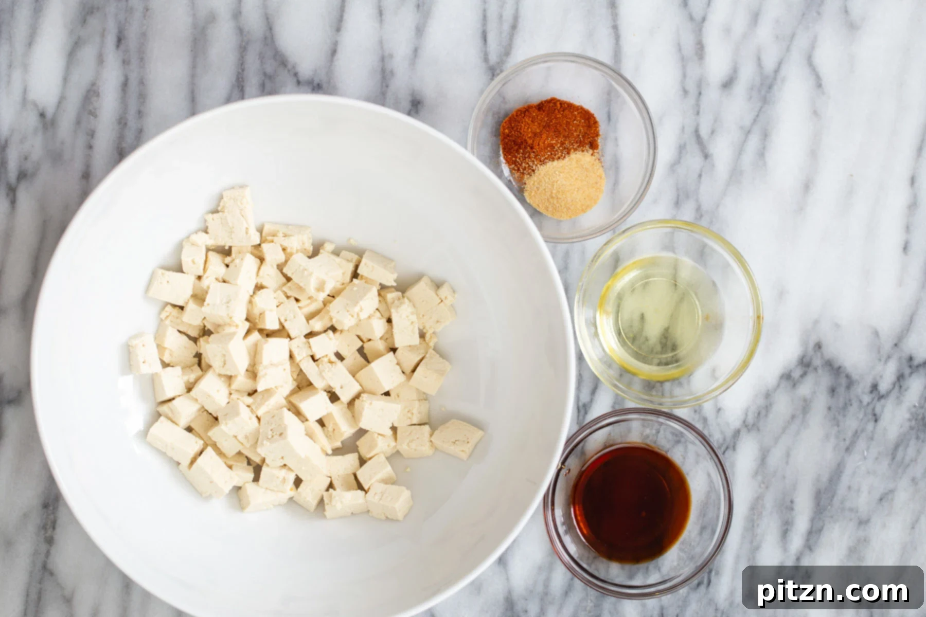 tofu cubes with condiments for making roasted crispy tofu as pasta topping
